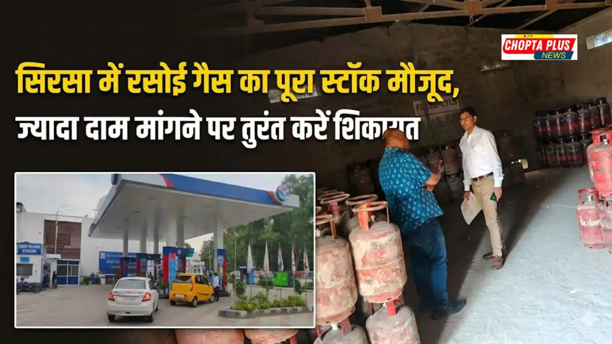An employee loading red domestic gas cylinders into a delivery vehicle at a gas agency warehouse in Sirsa.