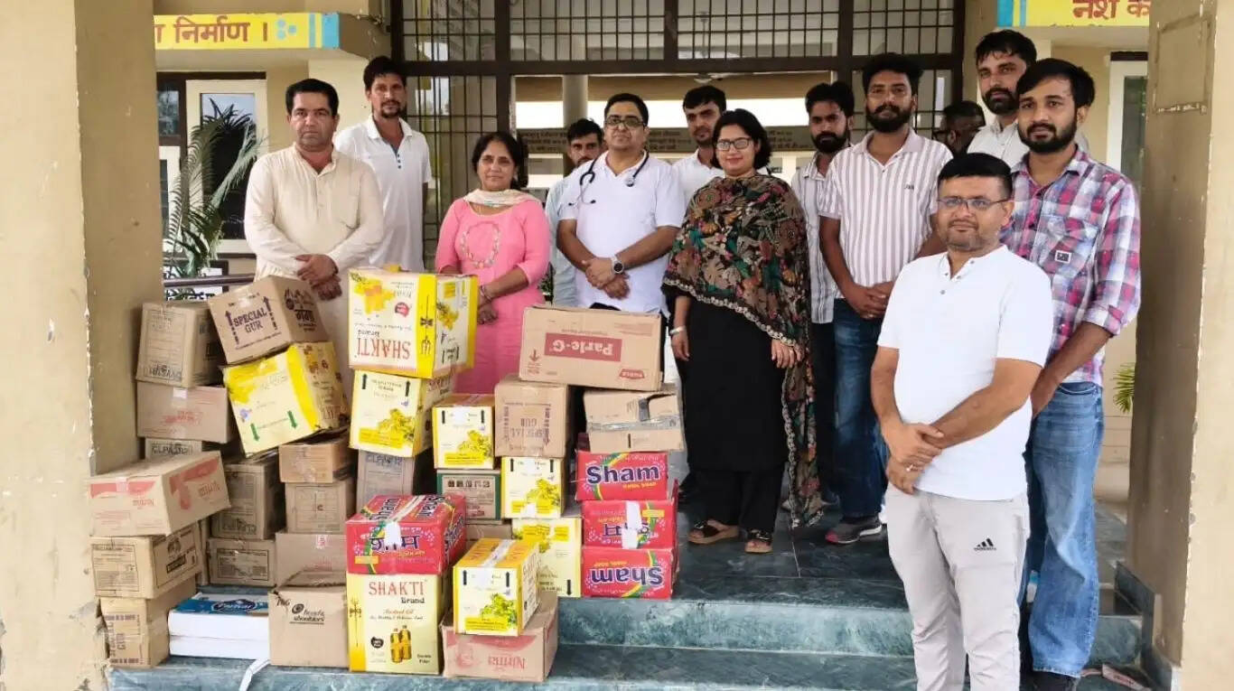 Social worker Raghubir Kadwasara handing over diet kits to doctors for TB patients at Community Health Centre Nathusari Chopta in Sirsa, Haryana